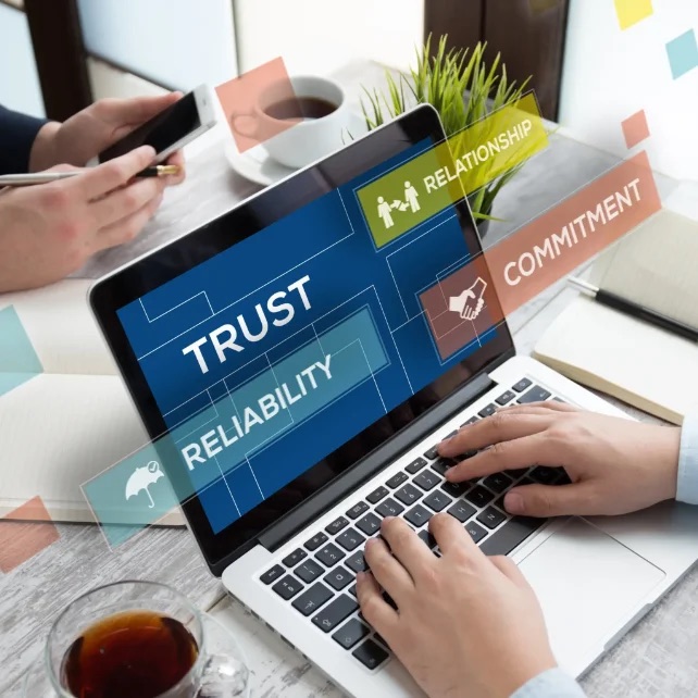 Laptop screen showing trust, reliability, relationship and commitment